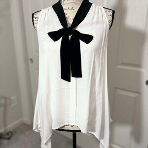 White Sleeveless Top with a Black Accented Bow with Pointed Hips & Pleated Neck